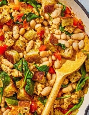 The ground turkey dinner in a skillet with a wooden spoon.